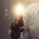 a closeup of light bulbs with one lit up