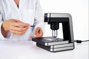 A veterinary professional uses the Vetscan Imagyst analyzer