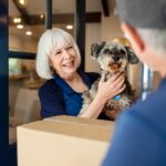 woman and her dog receive a box in the mail