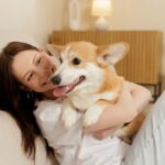 female pet owner on a couch with her dog