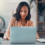 business woman sitting at laptop computer